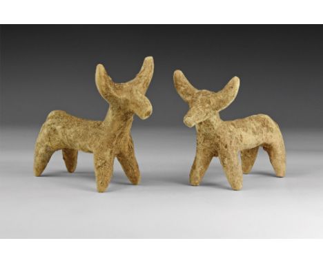 4th-3rd millennium BC. A group of two ceramic bull figures with long bodies, arching horns and short legs. 84 grams total, 90