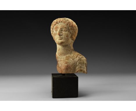 4th-1st century BC.
A ceramic bust of a female, possibly the goddess Persephone, in an archaistic style with rows of curls to