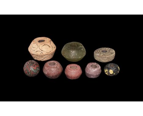 9th-11th century AD. A mixed group comprising: a truncated biconical ceramic whorl; a flat ceramic whorl with incised tribrac