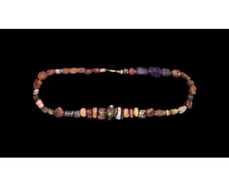 5th-7th century AD.
A restrung necklace of graduated beads of various types in polychrome glass, amber, agate and amethyst. 8