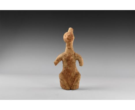 1st millennium BC. A ceramic figure of a seated female with round face, small pinched nose and lentoid eyes, conical extensio