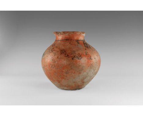 1st millennium BC. A ceramic jar with red-glazed surface, thick rolled rim, band of black painted lattice to the shoulder. 1.