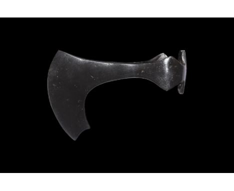 11th-12th century AD. An iron axehead with curved blade and spur to the inner edge; lateral flanges and extended panel to the