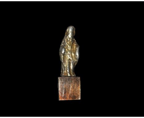 12th-13th century AD. A silver-gilt figurine showing a bearded male in flowing robes modelled in the round, the head surmount