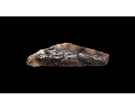 Neolithic, 4th-3rd millennium BC. A large bifacially knapped sickle with curved back, squared butt and straight cutting edge;