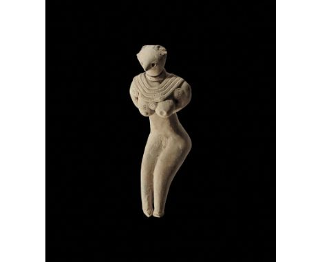 3rd-2nd millennium BC. A ceramic figurine with large applied hair collar and pendants to the shoulders, arms supporting the b