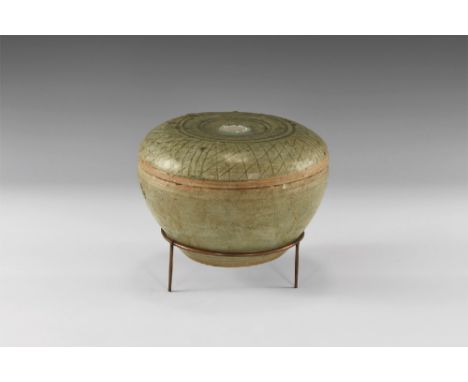 13th-16th century AD. A green glazed Sangkhalok Celadon ware pot with flat topped lid with curving sides secorated with a net