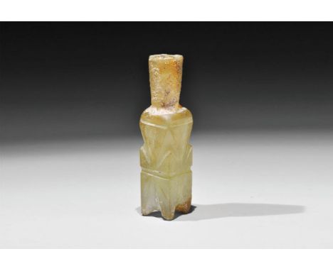 9th-11th century AD. A green glass molar flask with bulbous body and hexagonal-section funicular neck, four splayed feet to t