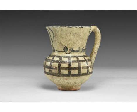 10th-12th century AD.
A cream-glazed ceramic jug with bulbous body, funicular neck, round-section loop handle; painted lattic
