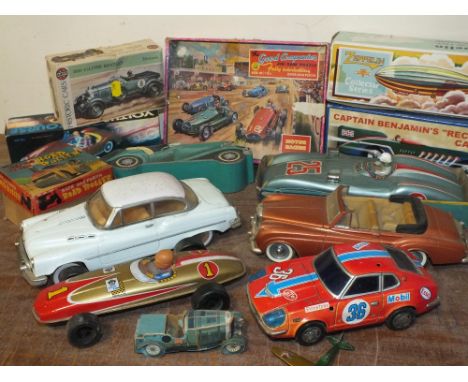 A COLLECTION OF MOSTLY VINTAGE REPRODUCTION TIN PLATE MODEL CARS, together with a boxed mechanical back and forth road roller