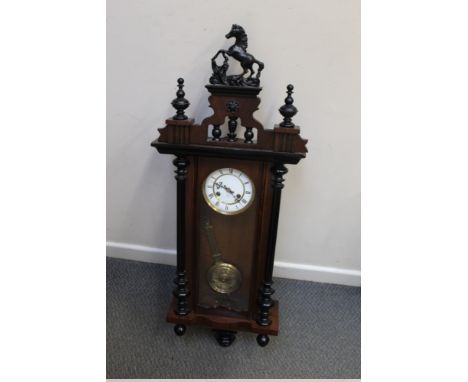 A VIENNA WALL CLOCK BY JUNGHANS WALNUT AND EBONISED WALL CLOCK,  H 108 cm