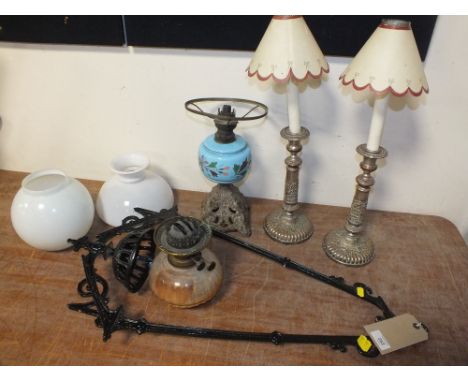 A CAST METAL HANGING OIL LAMP, overall H 81 cm, together with a table oil lamp with blue ceramic body and a pair of converted
