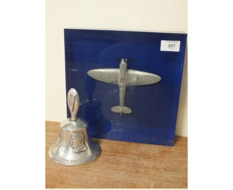 AN RAF BENEVOLENT FUND HAND BELL, together with a pewter model aircraft in blue / clear lucite block (2)