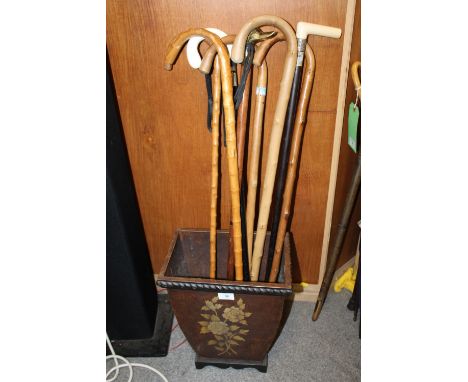 EIGHT ASSORTED WOODEN WALKING STICKS, to include a hallmarked silver banded ebonised example, contained in a modern stick sta