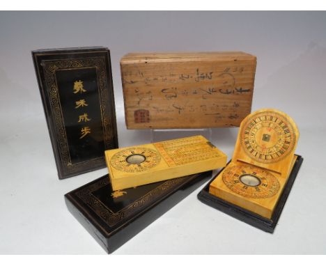 A BOXED CHINESE WOODEN COMPASS / SUNDIAL SET, the outer wooden box containing two lacquerware boxes and contents