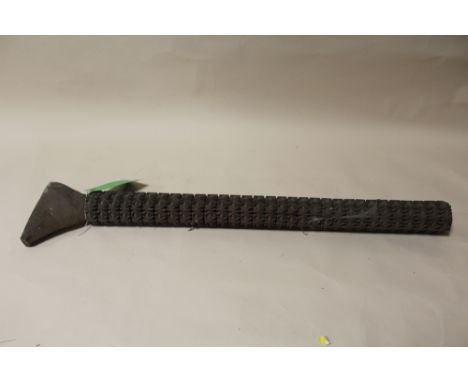 A COOK ISLANDS ADZE HANDLE, with all over carved decoration, minus blade, L 83 cm