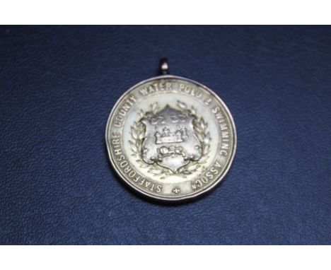 A HALLMARKED 9 CARAT GOLD STAFFORDSHIRE COUNTY WATER POLO AND SWIMMING ASSOCIATION MEDAL BY C USHER OF BIRMINGHAM, awarded fo