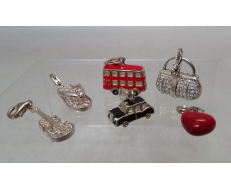 A SELECTION OF THOMAS SABO STERLING SILVER CHARMS,  comprising a London red bus, black cab, a cello, handbag, enamel heart an