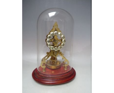 A SKELETON CASED TORSION CLOCK BY BMA, having a waisted form framework, silvered convex Arabic numerals and large pendulum di