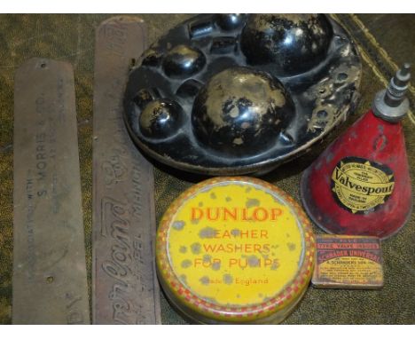A SELECTION OF VINTAGE CAR MEMORABILIA, to include a pre-war circular metal spare bulb holder, a valve spout and two machine 