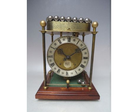A THWAITES AND REED ROLLING BALL CLOCK,  powered by a series of steel balls on a ferris wheel style movement, the brass four 