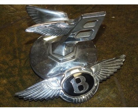 A VINTAGE CHROME BENTLEY 'FLYING B' CAR MASCOT RADIATOR CAP, together with another chrome Bentley badge (2)