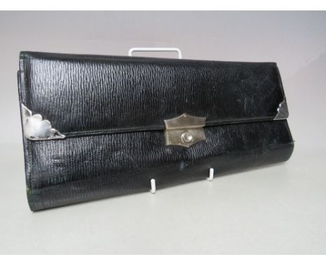A VINTAGE LEATHER TRAVEL WALLET FOR GLOVES AND HANDKERCHIEFS, black textured leather exterior with hallmarked silver corner p
