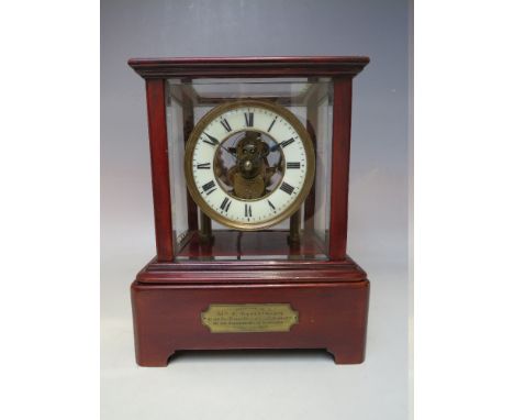 AN EARLY TWENTIETH CENTURY EUREKA BATTERY OPERATED MANTEL CLOCK, under a five glass mahogany case, the intricate geared skele