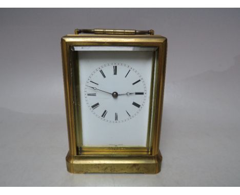 A FINE JULES OF PARIS BELL STRIKE CARRIAGE CLOCK, the brass gorge case having large bevelled glass panels, enamel dial and si