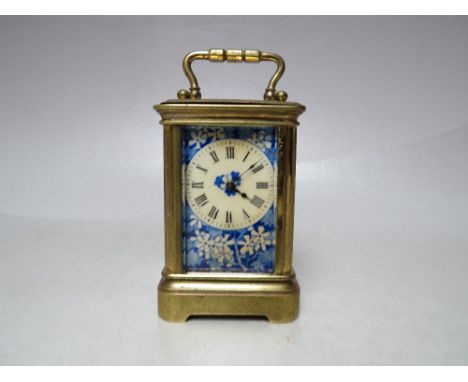 A FINE MINIATURE FRENCH CARRIAGE CLOCK, having a brass case, blue floral enamelled dial and enamelled panels to rear door and