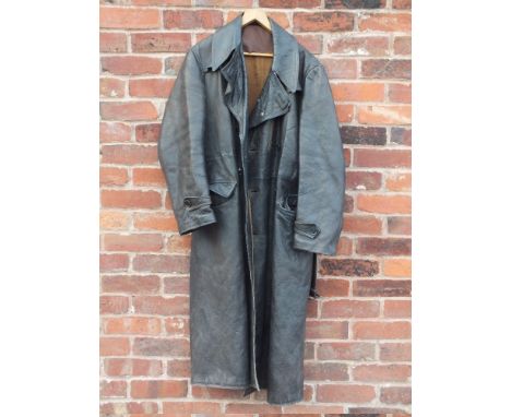 A GENTS VINTAGE MILITARY STYLE FULL LENGTH LEATHER COAT, complete with original belt, damage to lining, wear commensurate wit