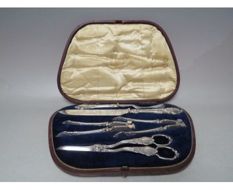 A LATE 19TH / EARLY 20TH CENTURY SILVER PLATED FRUIT AND NUT SET, with silver handles serving knife and fork