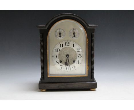 AN EARLY TWENTIETH CENTURY OAK CASED WESTMINSTER CHIME MANTEL CLOCK, silvered dial, the case with barleytwist columns, pendul