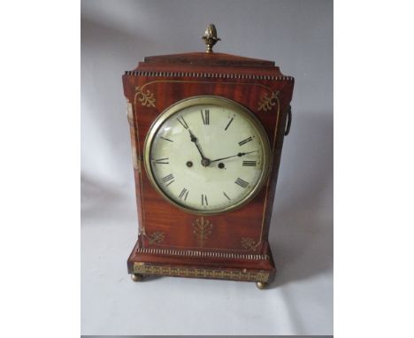 A NINETEENTH CENTURY REGENCY MAHOGANY MANTEL CLOCK, of classical outline, the mahogany casing decorated with inlaid brass det