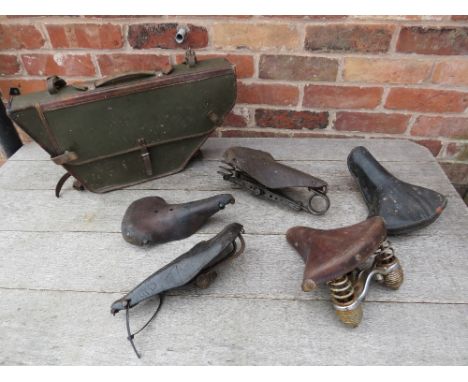 A SELECTION OF VINTAGE BICYCLE SADDLES, together with a WWII army bicycle leather frame bag
