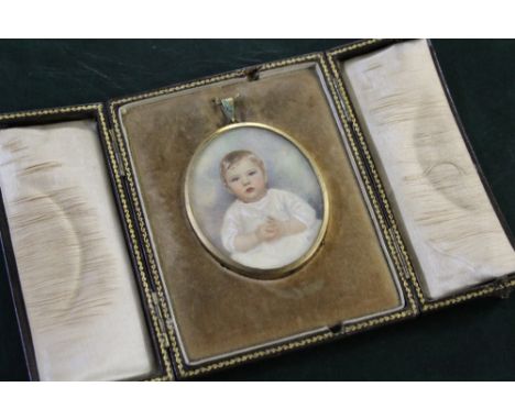 AN OVAL PORTRAIT MINIATURE OF A YOUNG CHILD, Indistinctly signed lower right, framed in a gold metal frame and glazed, set in