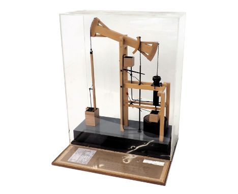 A scale model of a Newcomen's pumping engine from the 19thC, in glazed wooden case with informative display board, 50cm wide.