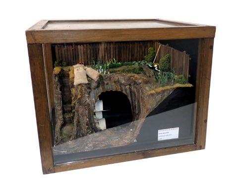 A scale model of an Anderson shelter, in perspex and pine case, 49cm wide. 