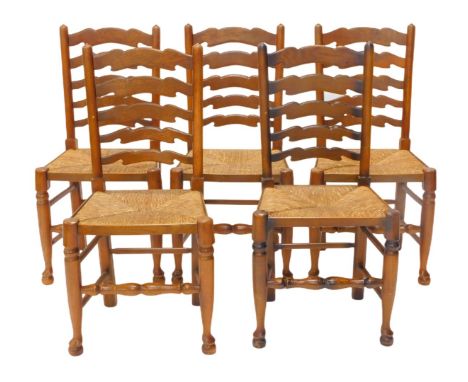 A set of five Lancashire type ladder back dining chairs, each with a rush seat on turned tapering legs. 