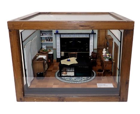 A scale model of a Morrison shelter, containing furniture, cooking range, etc., in pine and perspex case, 46cm wide. 