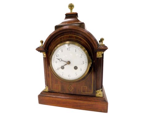 A 19thC mahogany mantel clock, with turret top and column supports, with brass string inlay and a white enamel numeric face, 