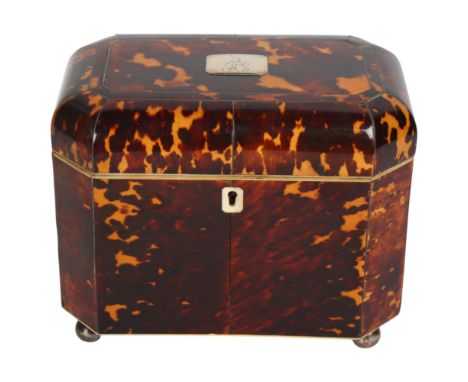 An early 19th century tortoiseshell and silver inlaid tea caddy, with silver crest inset to the lid, original inner lids and 