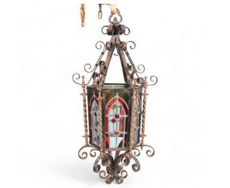 A wrought-iron framed lantern light fitting, with leadlight coloured glass inset panels, height 77cm