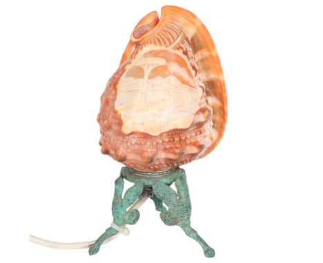A cameo carved conch shell lamp, depicting the Bay of Naples and Vesuvius, on bronze tripod base, height 21cm, working order