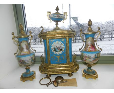 A French Sevres style clock garniture, the ormolu and porcelain clock of Empire style with vase finial flanked by a pair of c