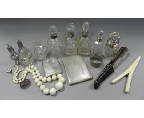 A silver cigarette case together with silver mounted dressing table jars, two silver mounted glass salts, silver pepperettes,