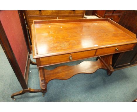 A Victorian mahogany washstand, the bevelled rectangular top with low gallery back on waisted bracket end standards, joined b