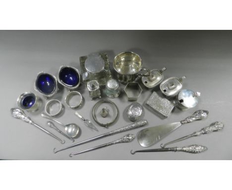 A collection of silver mounted button hooks together with silver napkin rings, a silver bangle, a silver snuff box, a silver 
