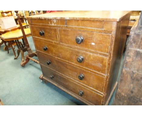 A Victorian scumbled pine oak effect chest of two short and three long graduated cockbeaded drawers with ebonised knob handle
