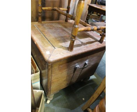 A commode / thunder box with ceramic castors